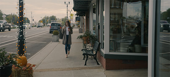 Woman walking on sidewalk in downtown Sweetwater, TN